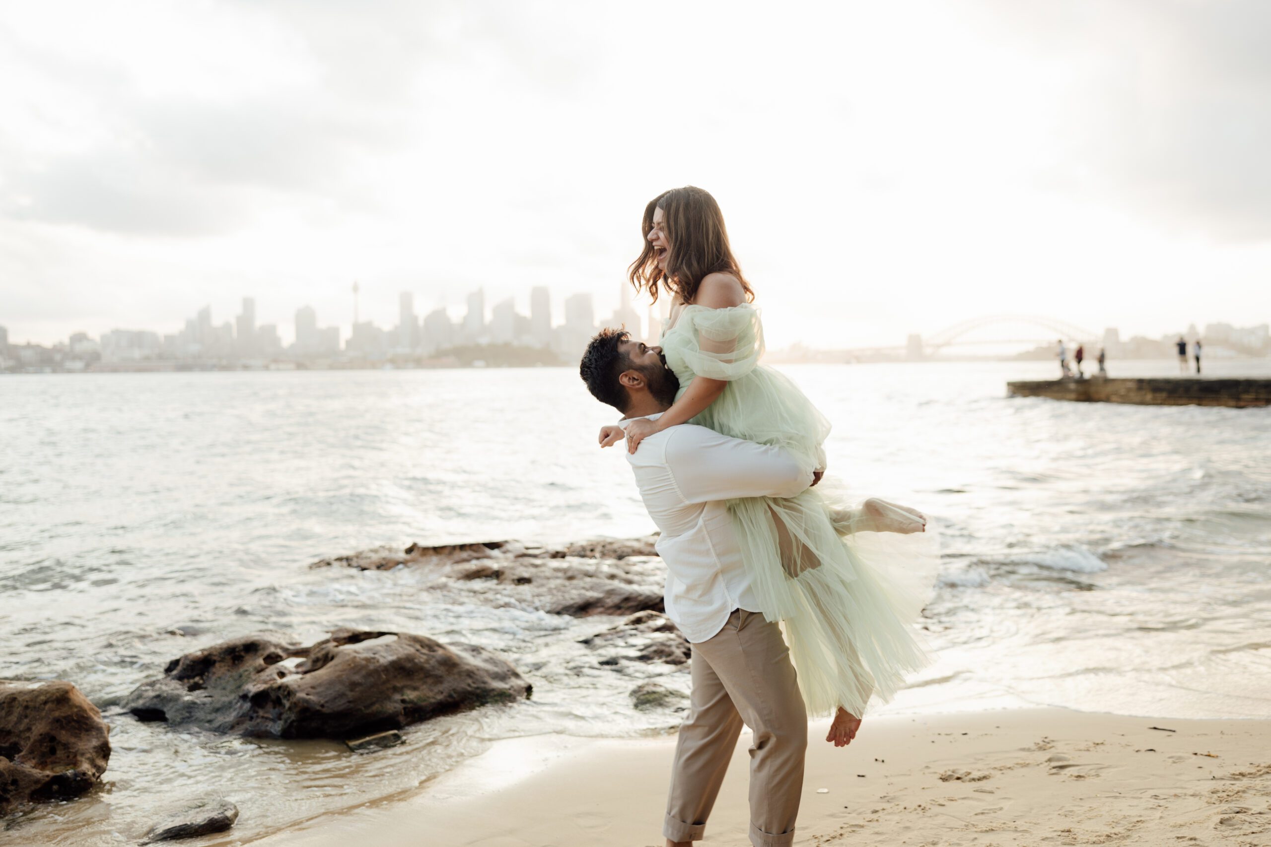 couple on the beach with Sydney Harbour views